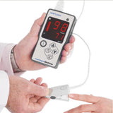 Smartsigns MiniPulse MP1R Handheld Rechargeable Pulse Oximeter with Finger Sensor being placed on patient